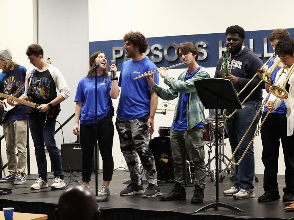 A group of people singing on a stage