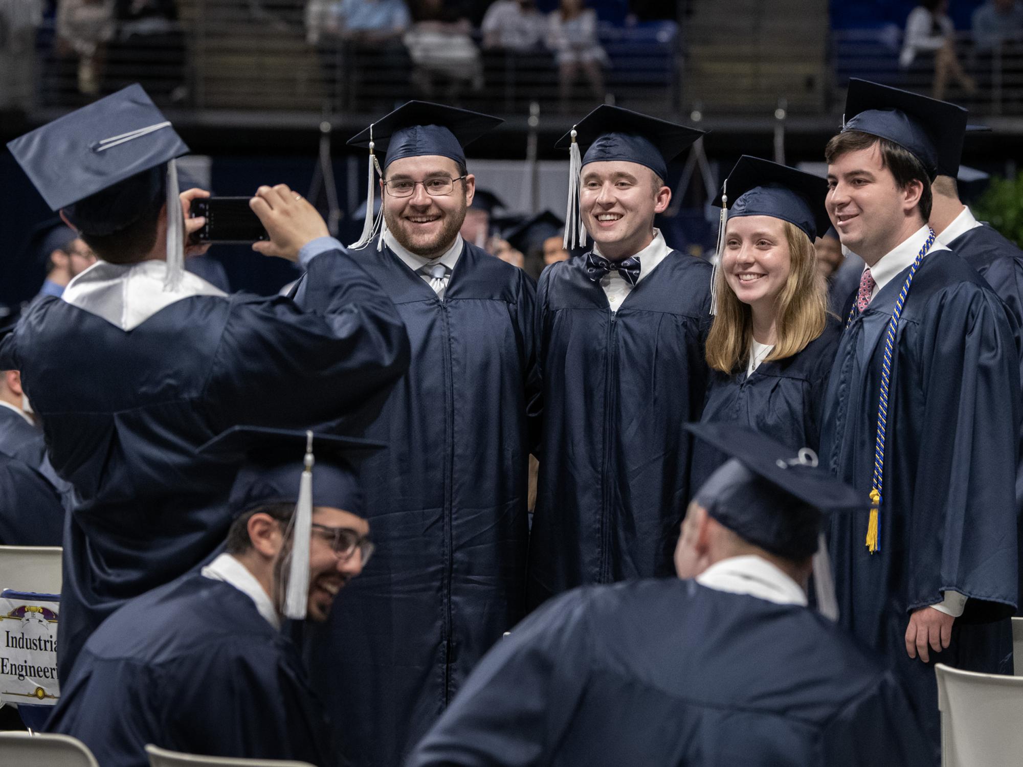 graduates pose for a photo