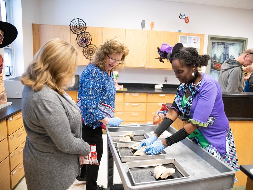 Carol Evans interacting with visitors during a Halloween Open House event.