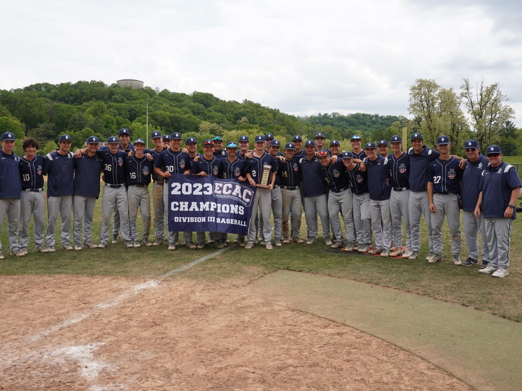 The Penn State Behrend baseball team poses with the ECAC championship banner.