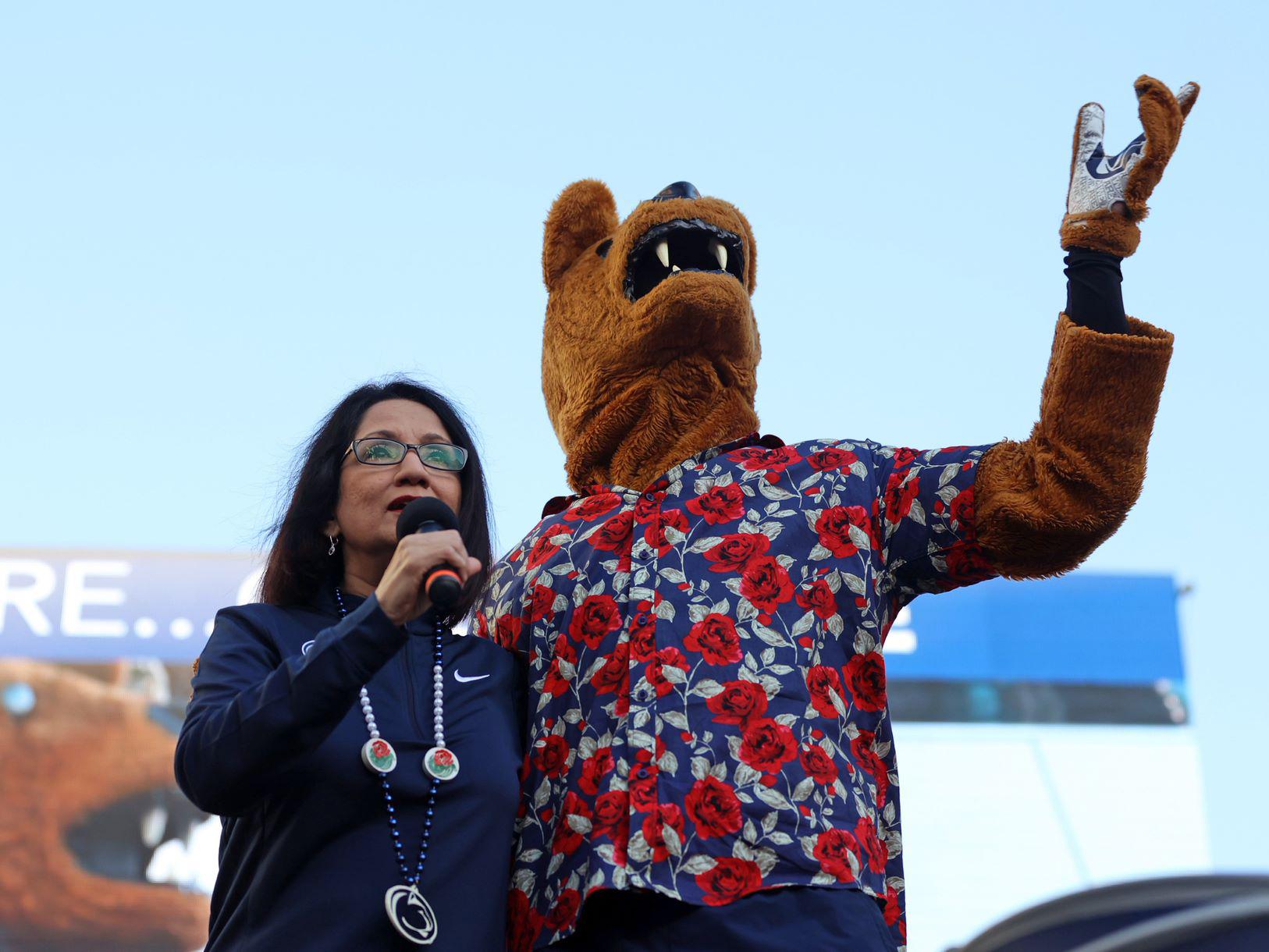 Neeli Bendapudi stands with the Nittany Lion mascot and addresses the crowd at a Rose Bowl pep rally held in Pasadena, California.