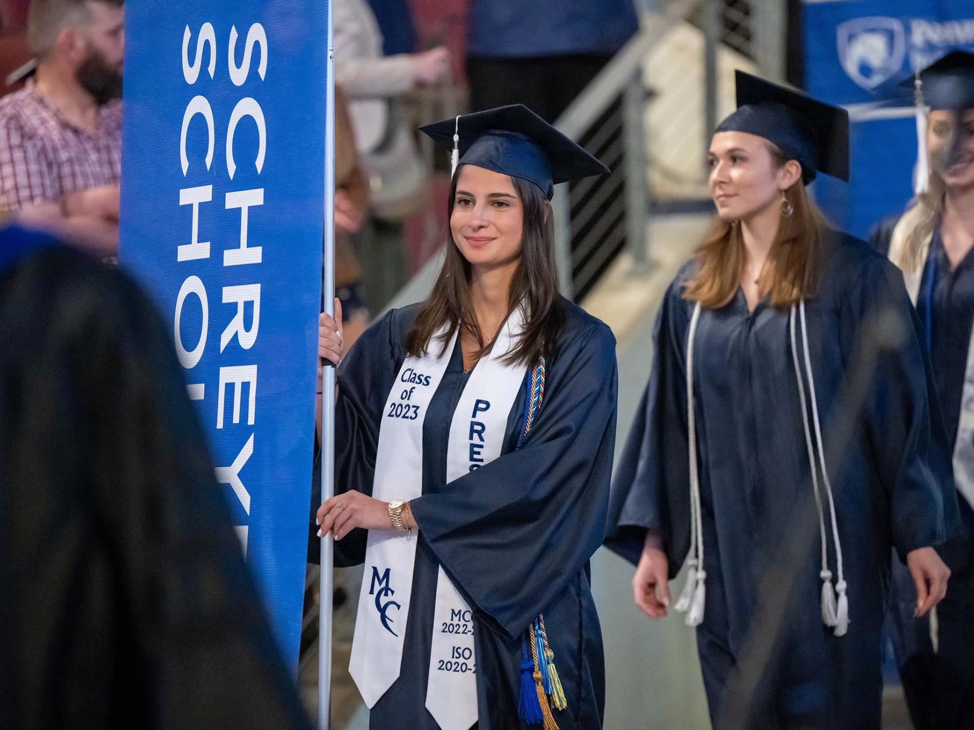 A student marshal enters Erie Insurance Arena during Penn State Behrend's spring 2023 commencement ceremony.