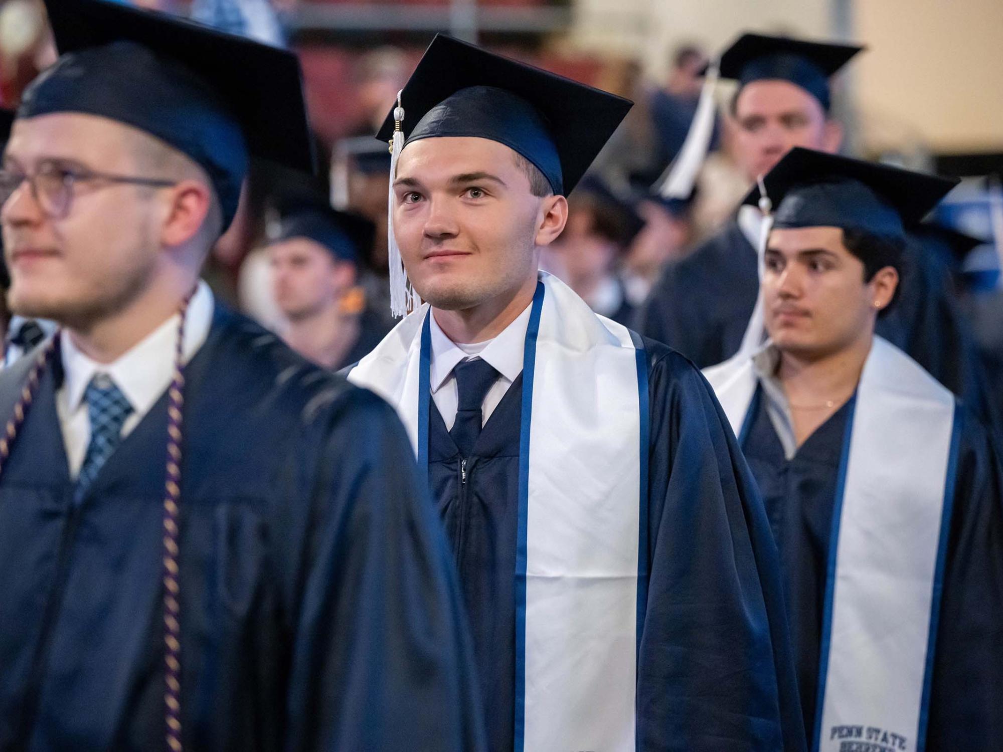 Graduates process into Erie Insurance Arena at the beginning of Penn State Behrend's spring 2023 commencement ceremony.
