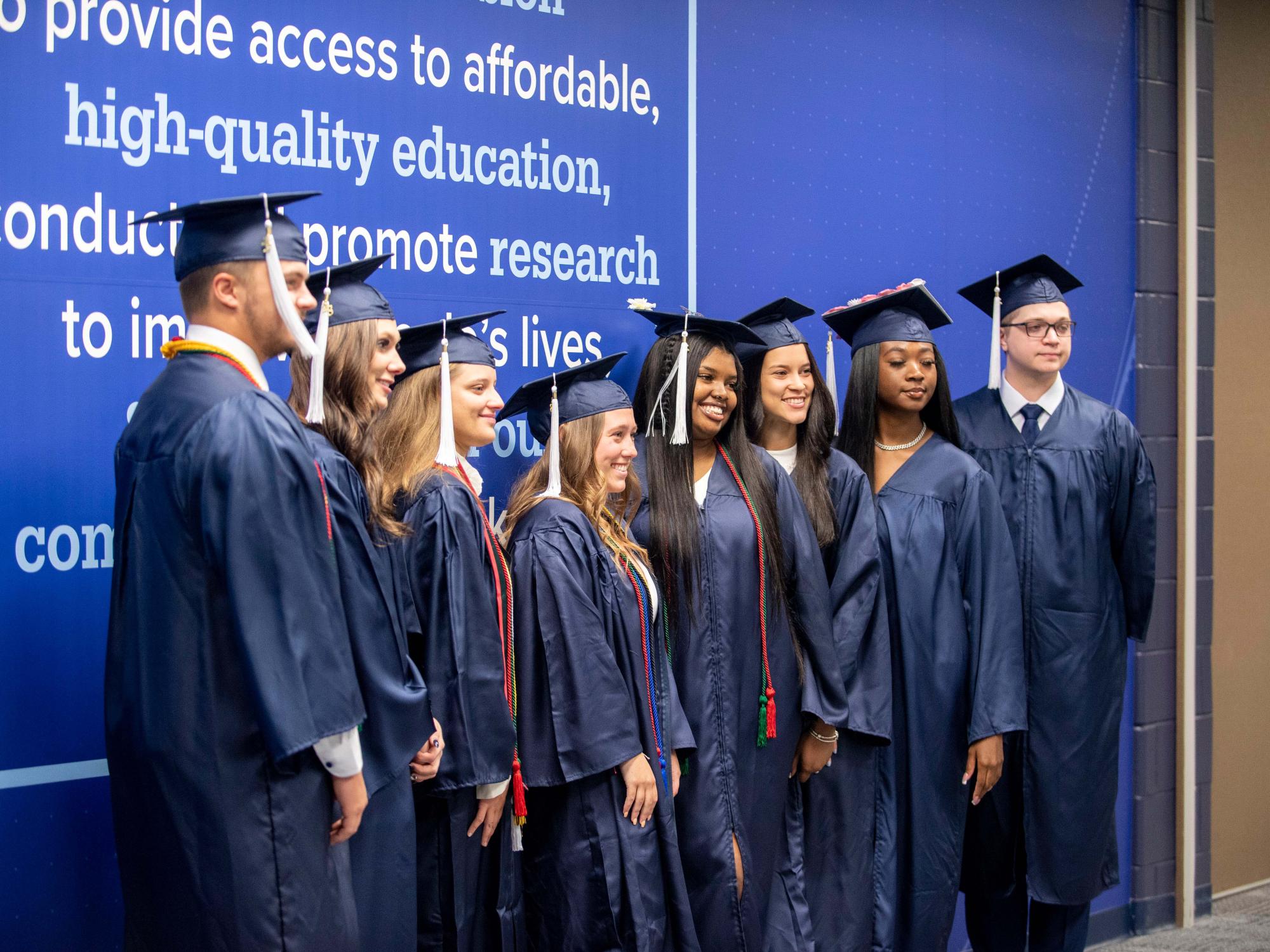 Graduating students posing in the Health and Wellness Building at Penn State Schuylkill