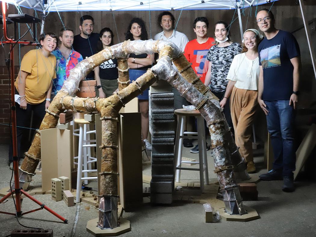 The ForMat Lab researchers involved in the MycoCreate project pose behind the first version of the installation.