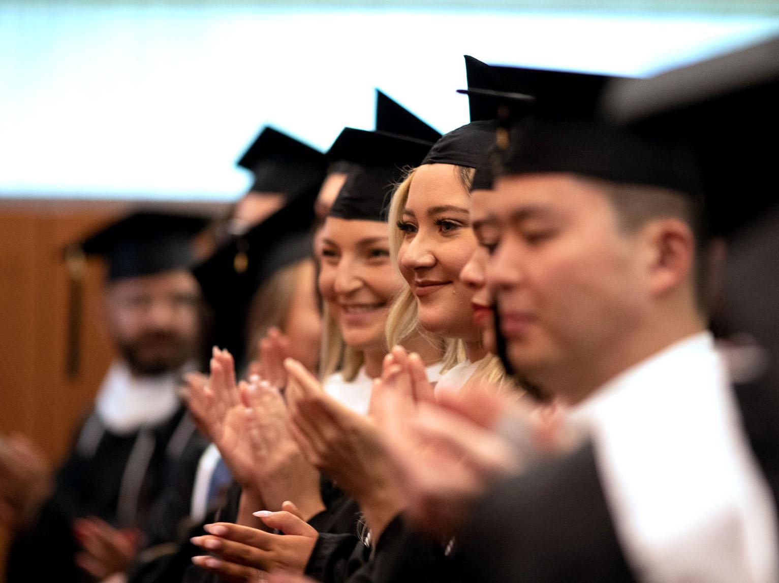 SIA Class of 2023 graduates clapping during the ceremony.
