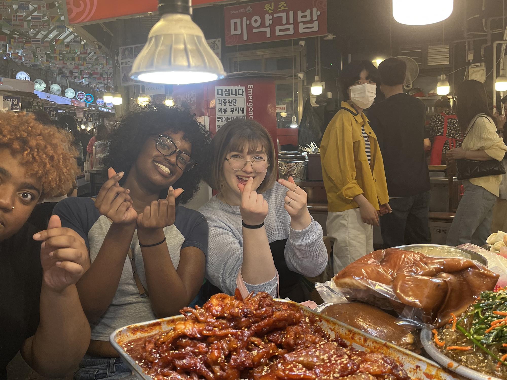 Alexis Pupo (middle), Daja, and Tay at a traditional food market in Seoul, South Korea.
