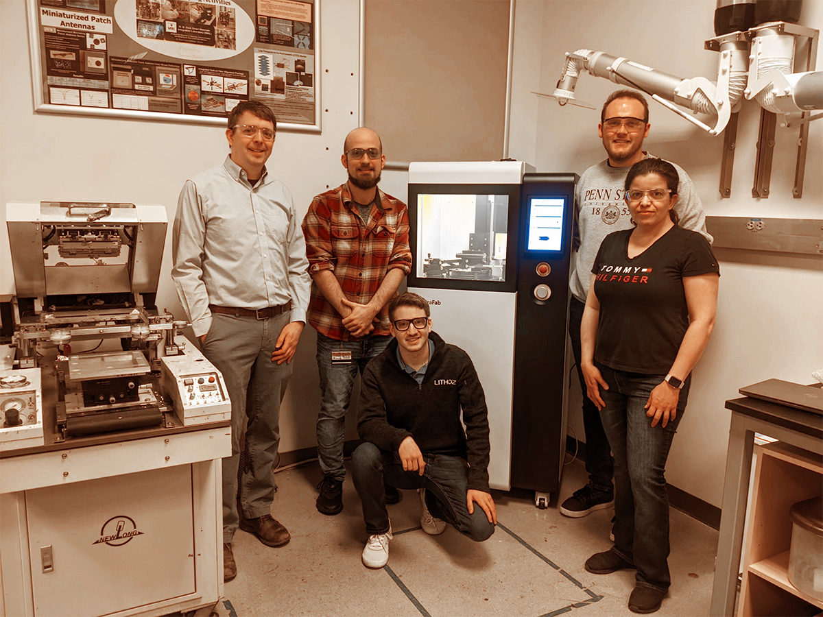 Group of people posing with newly installed 3D ceramic printer in Nanofab Lab. 
