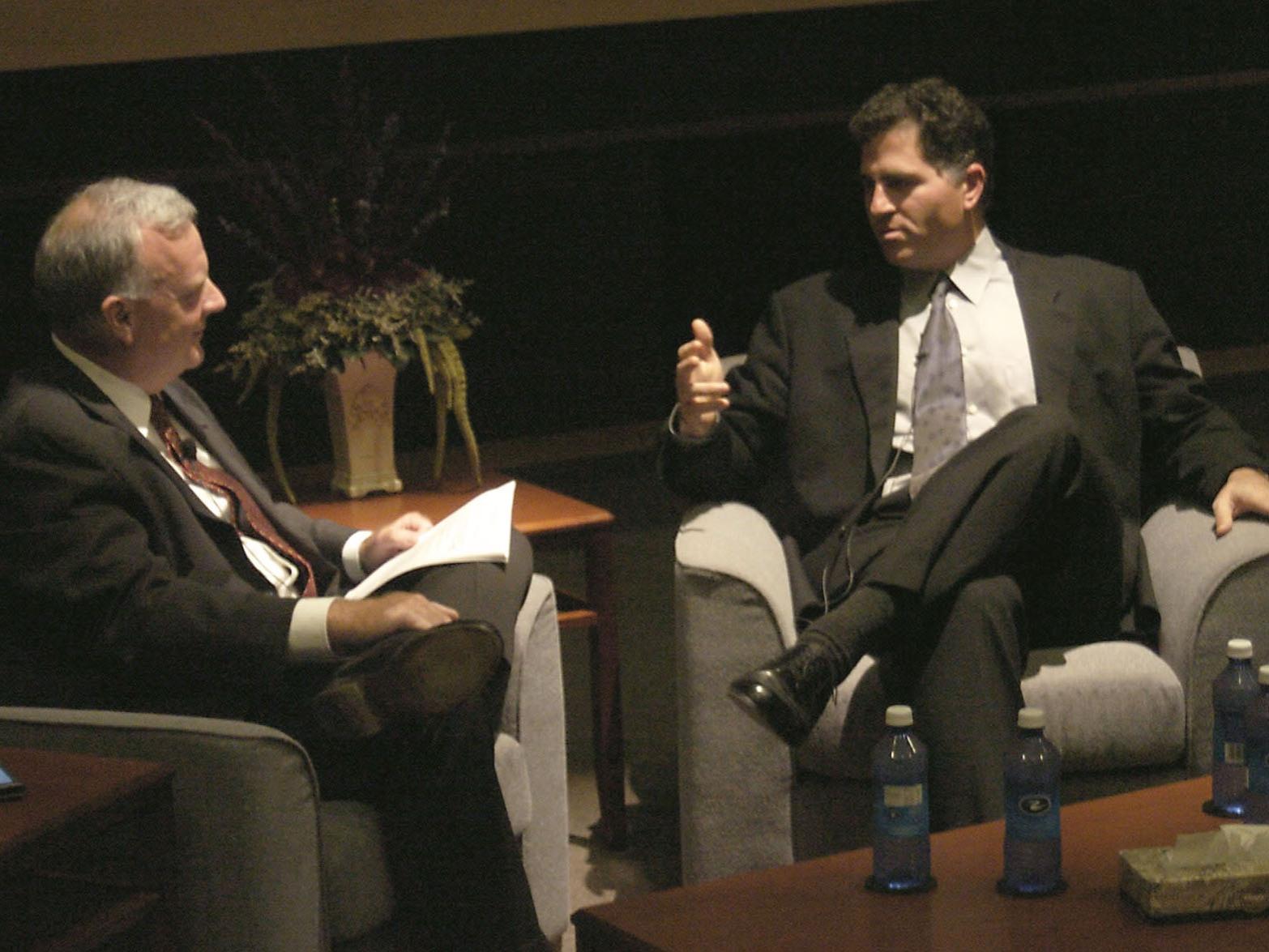 A photo of Jim Thomas talking with Michael Dell.