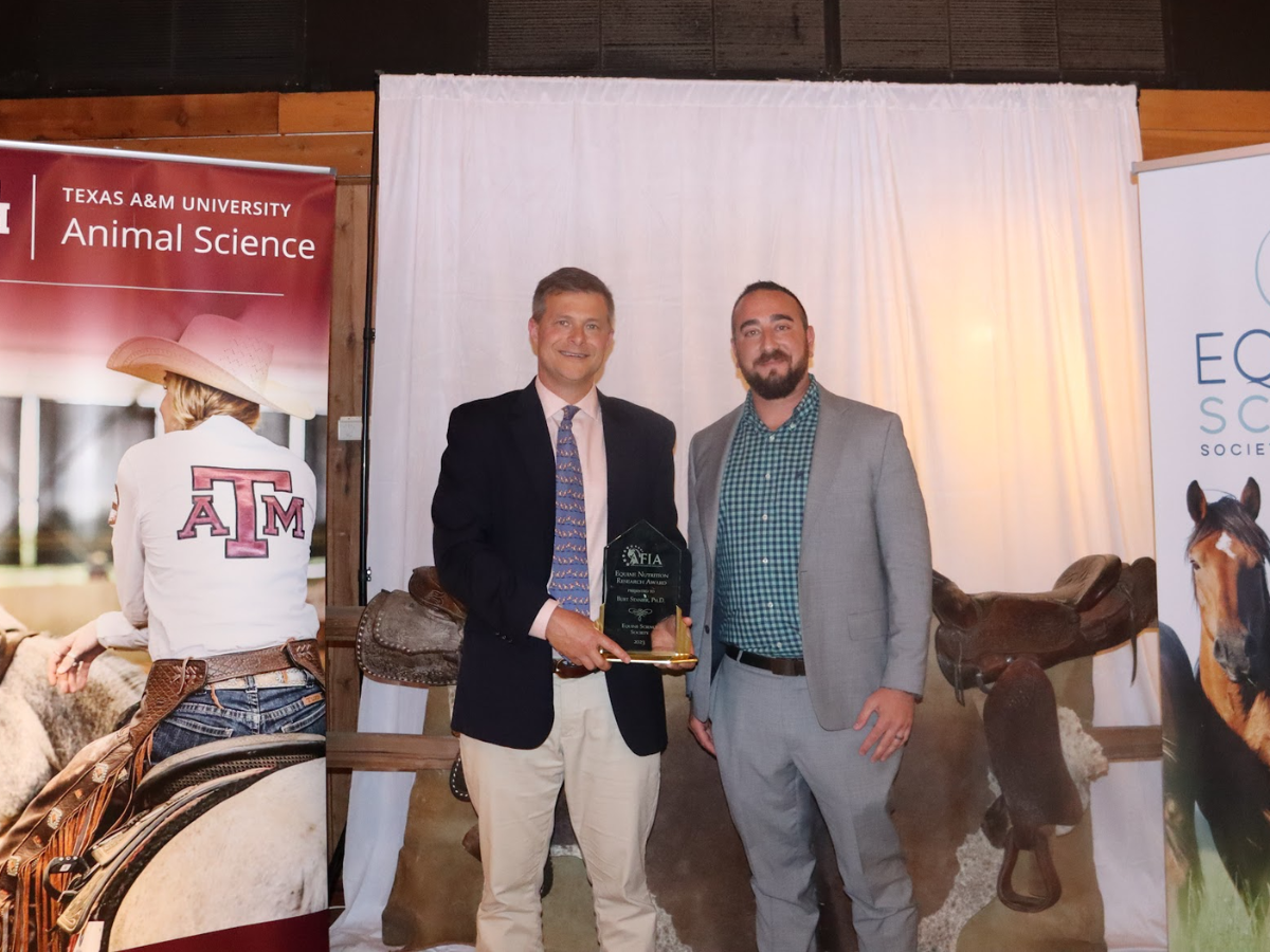 Burt Staniar posing for the camera holding his award