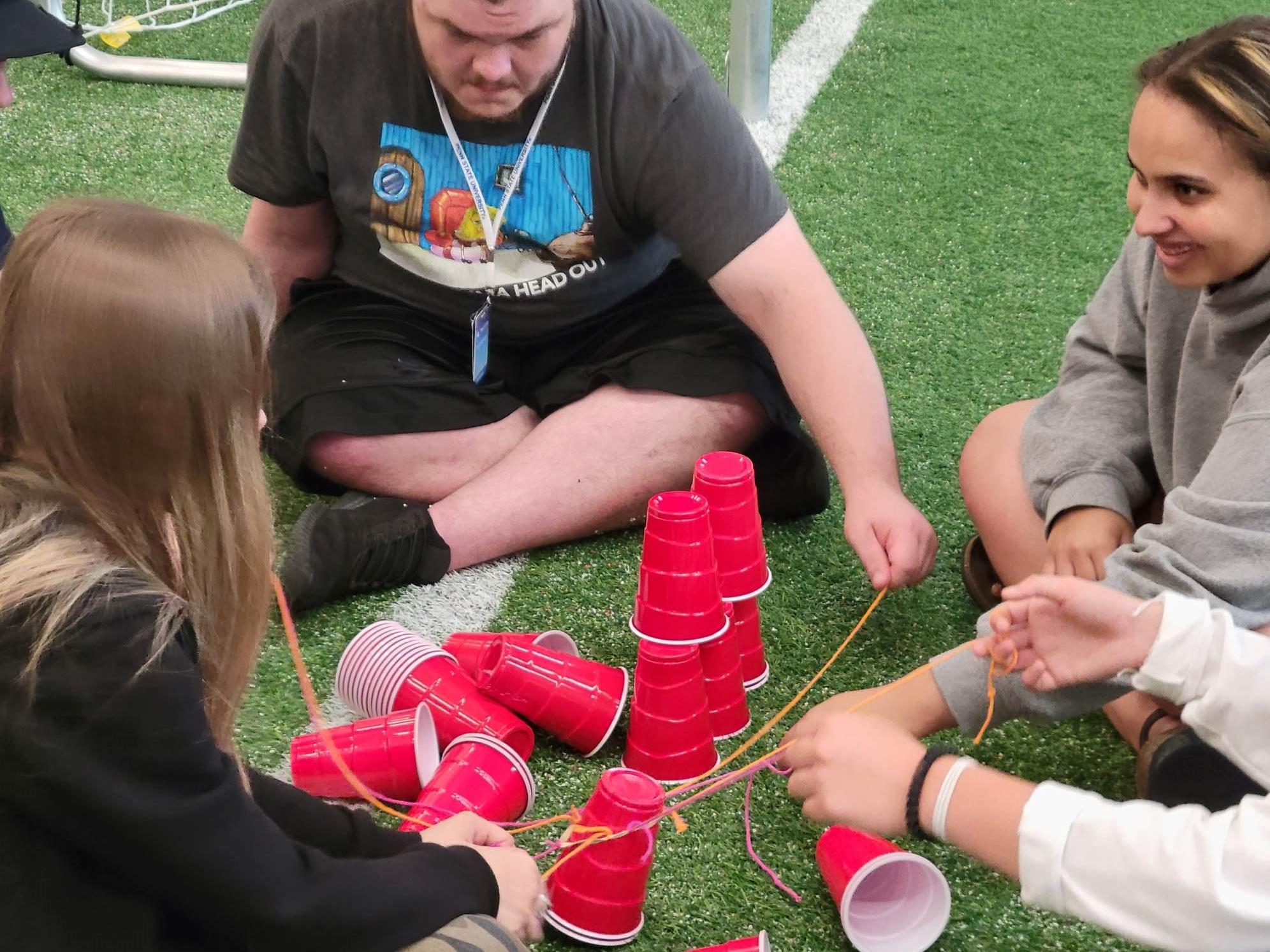 Fostering Little Lions Camp play a game together.