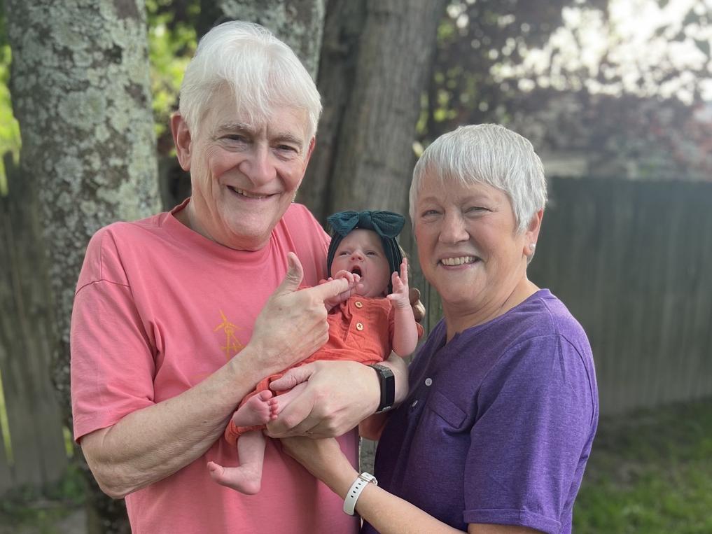 two grandparents with infant