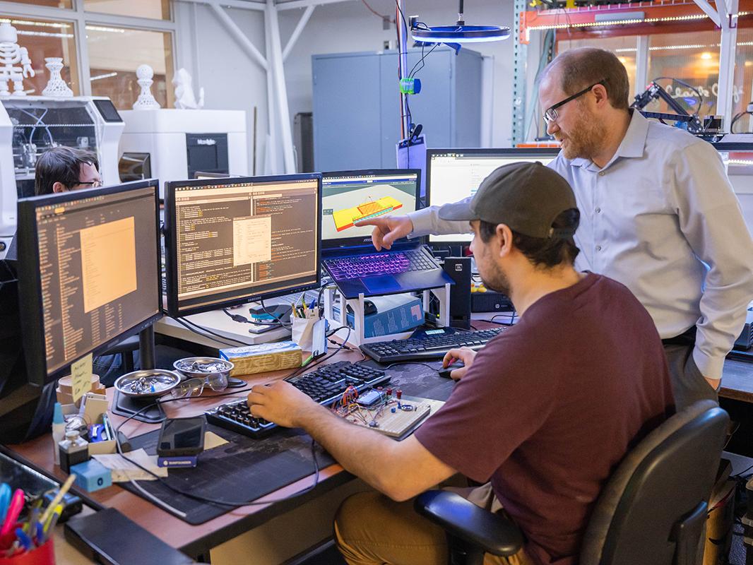 Student and faculty working at computer