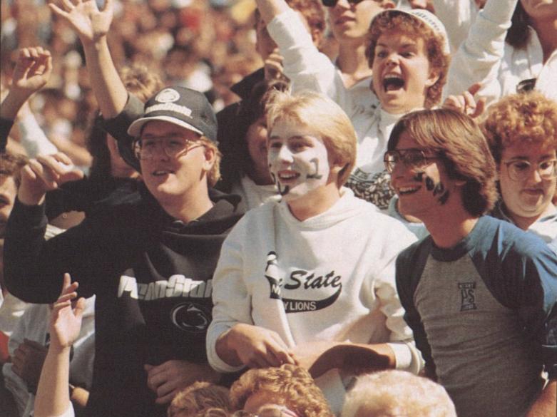 A close up shot of three male students in the stands at Beaver Stadium in 1986