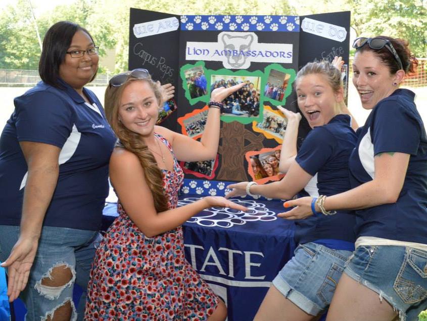  A group of four students at the Lion Ambassadors table at the Involvement Fair.