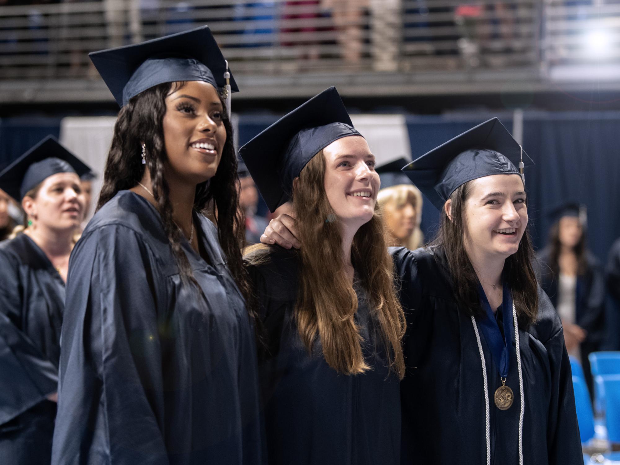 graduates singing the alma mater