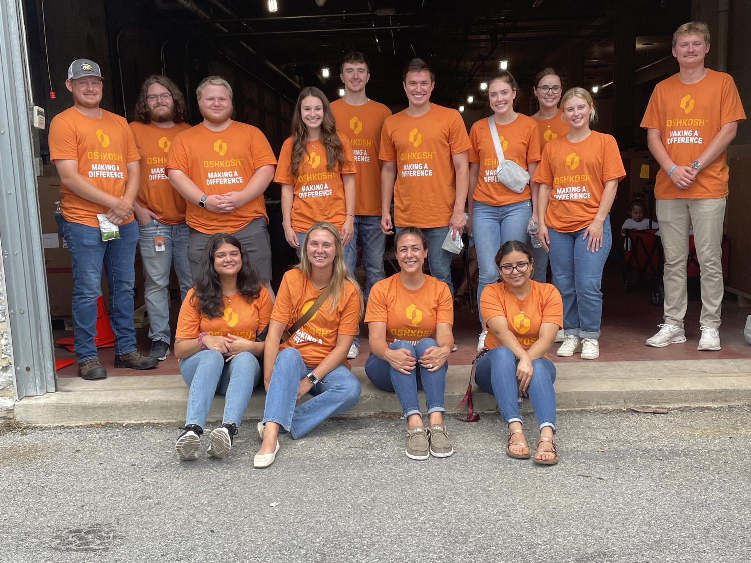 Gargee Gosavi (bottom row far left, sitting on the ground) poses with her fellow JLG Industries interns. 