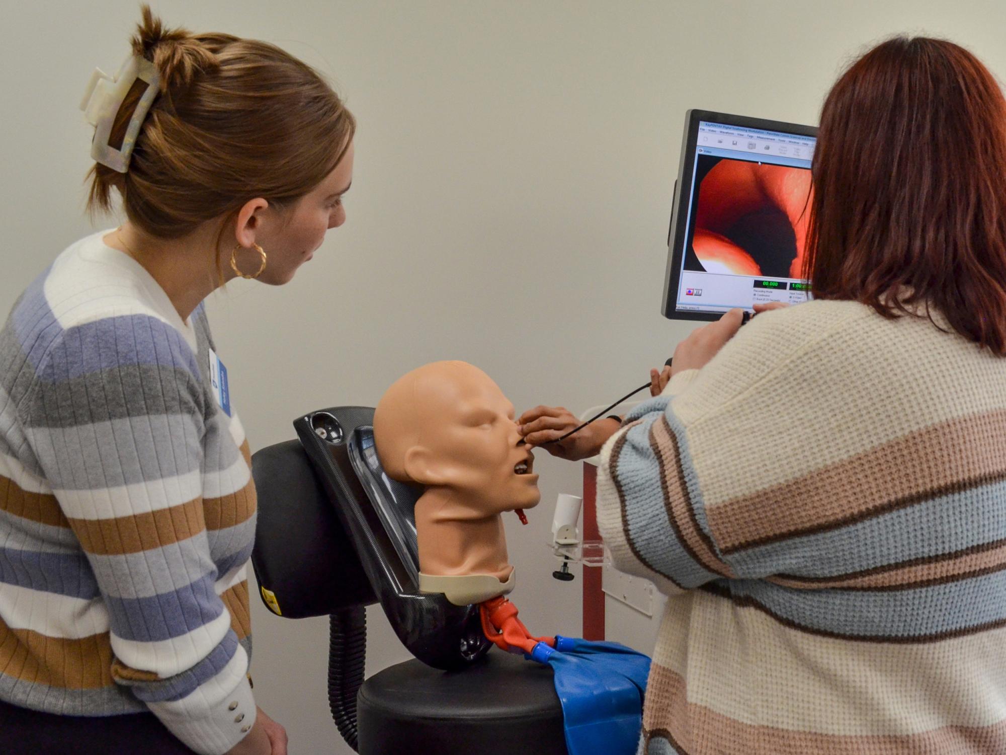Students practice with a nasal camera on a dummy head