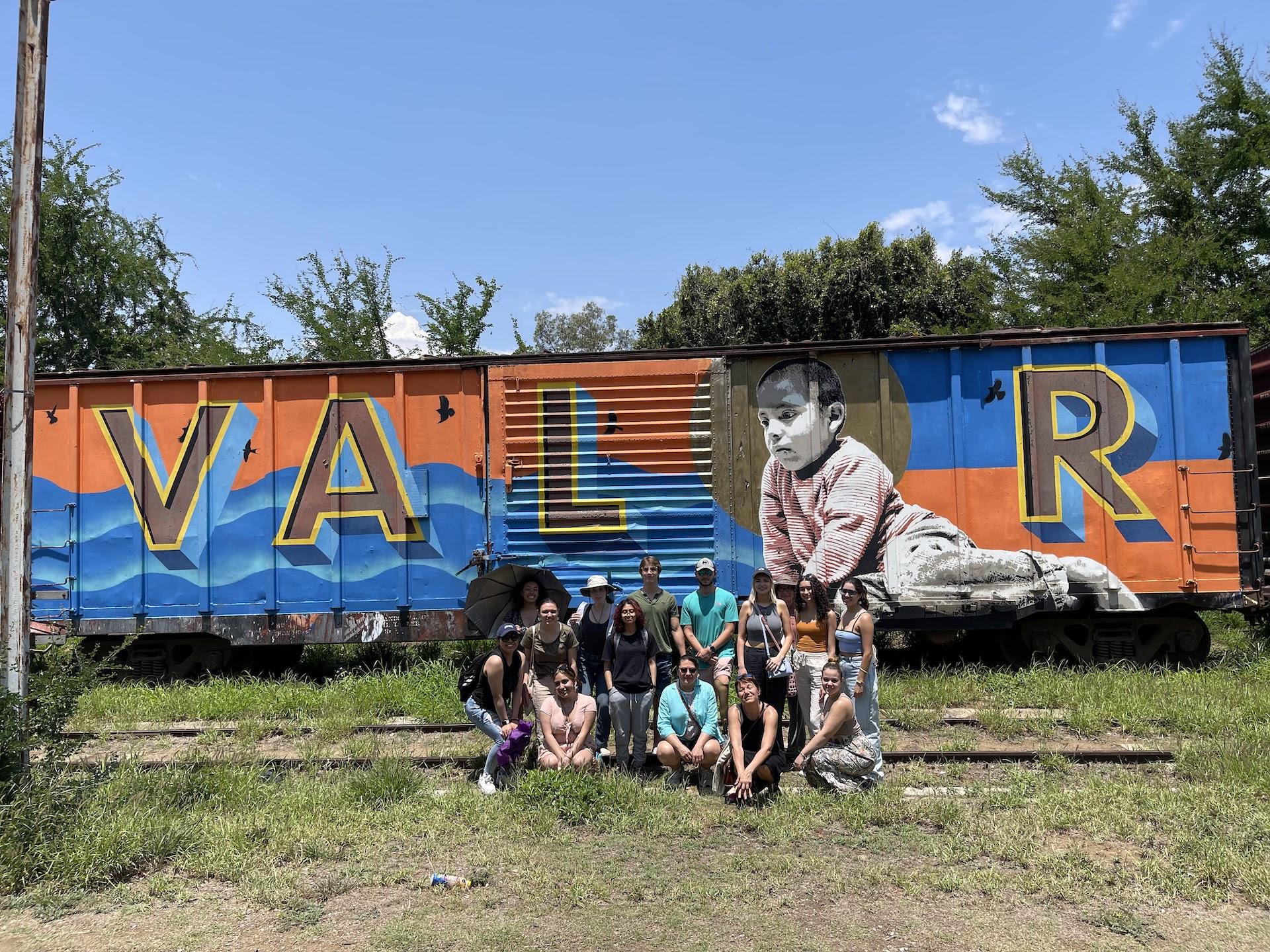 students in front of train