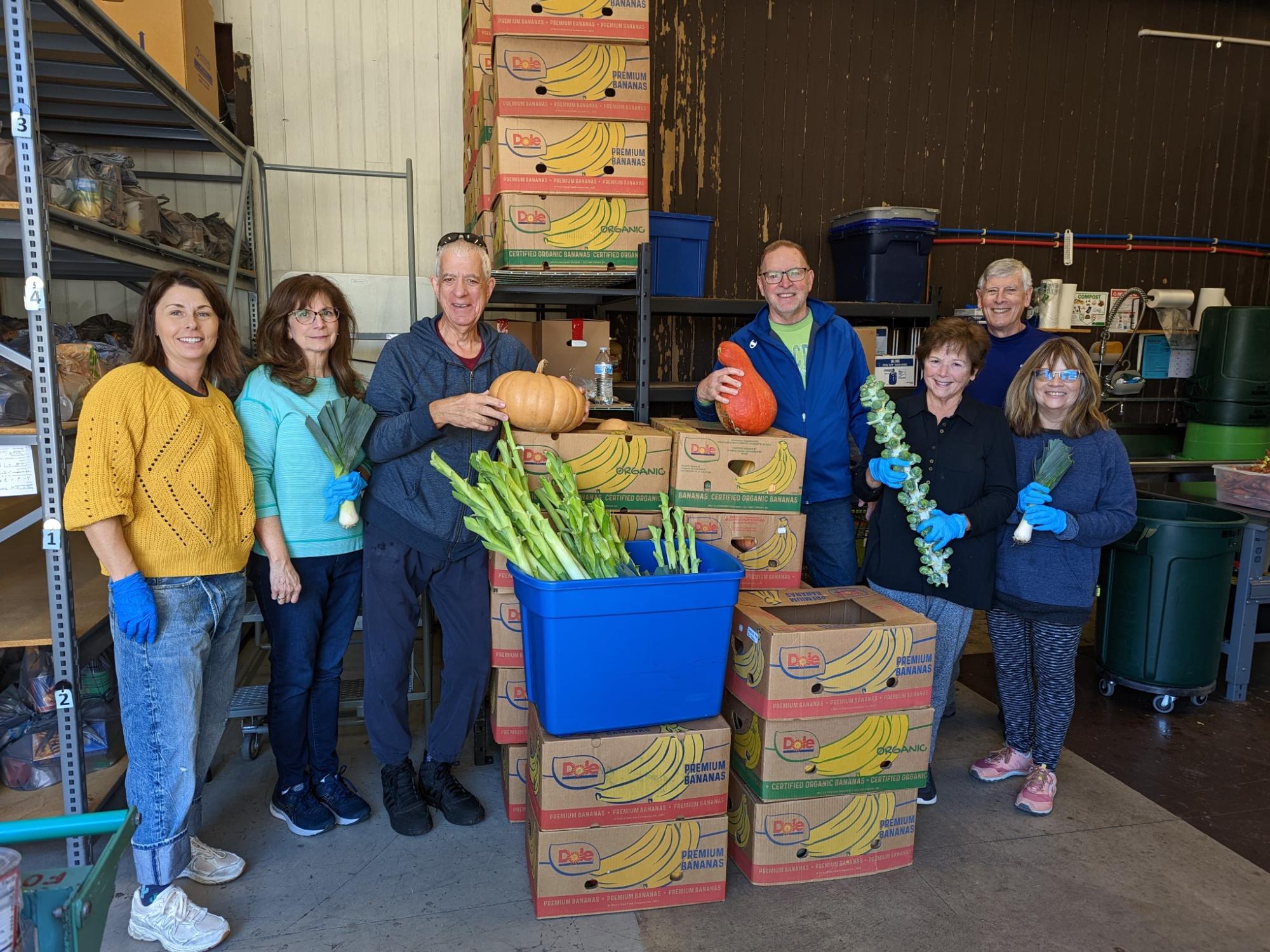 Arboretum volunteers standing with vegetables being donated