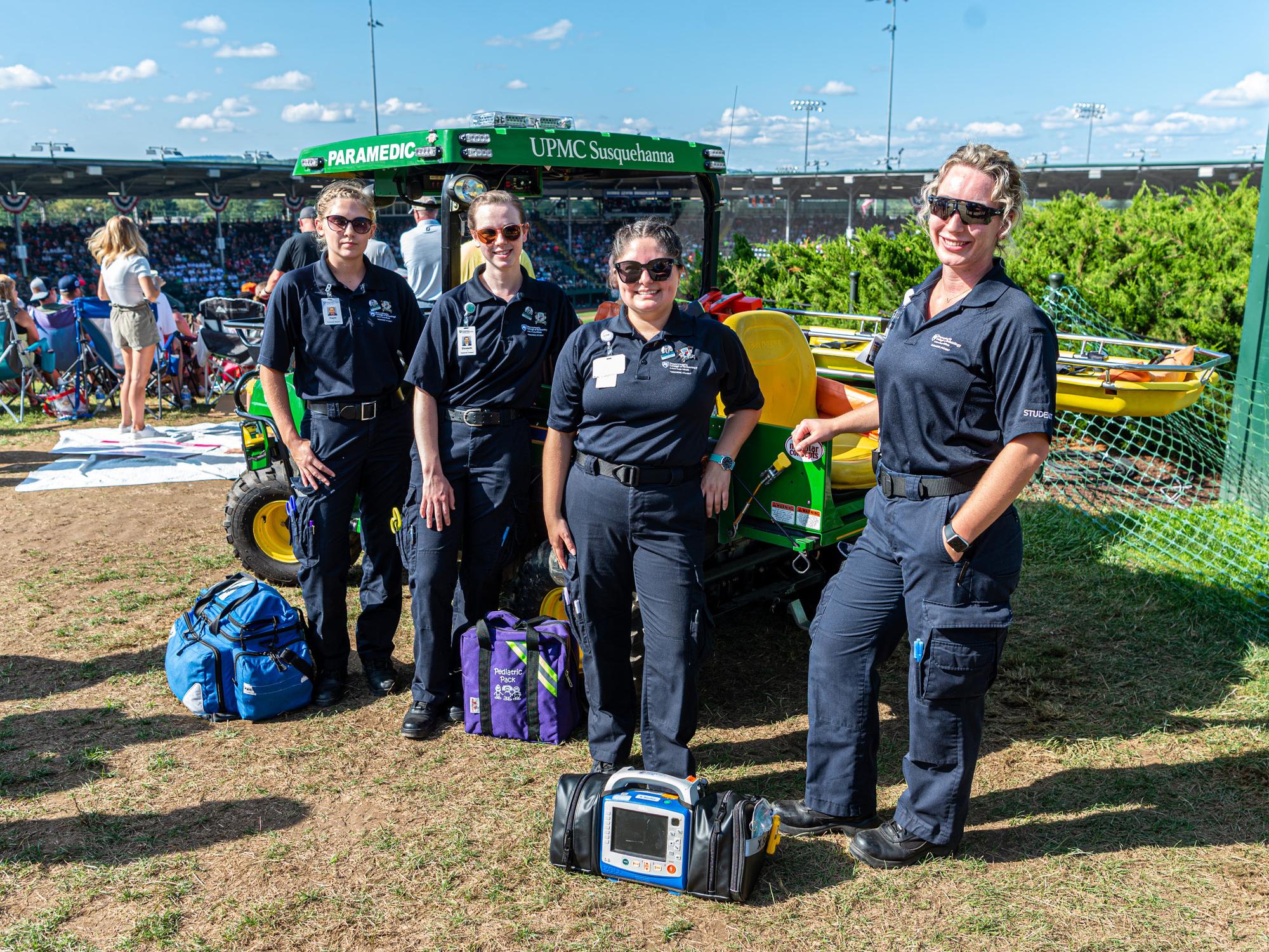 A group of Penn College paramedic science students stand in a line outdoors at the Little League World Series.
