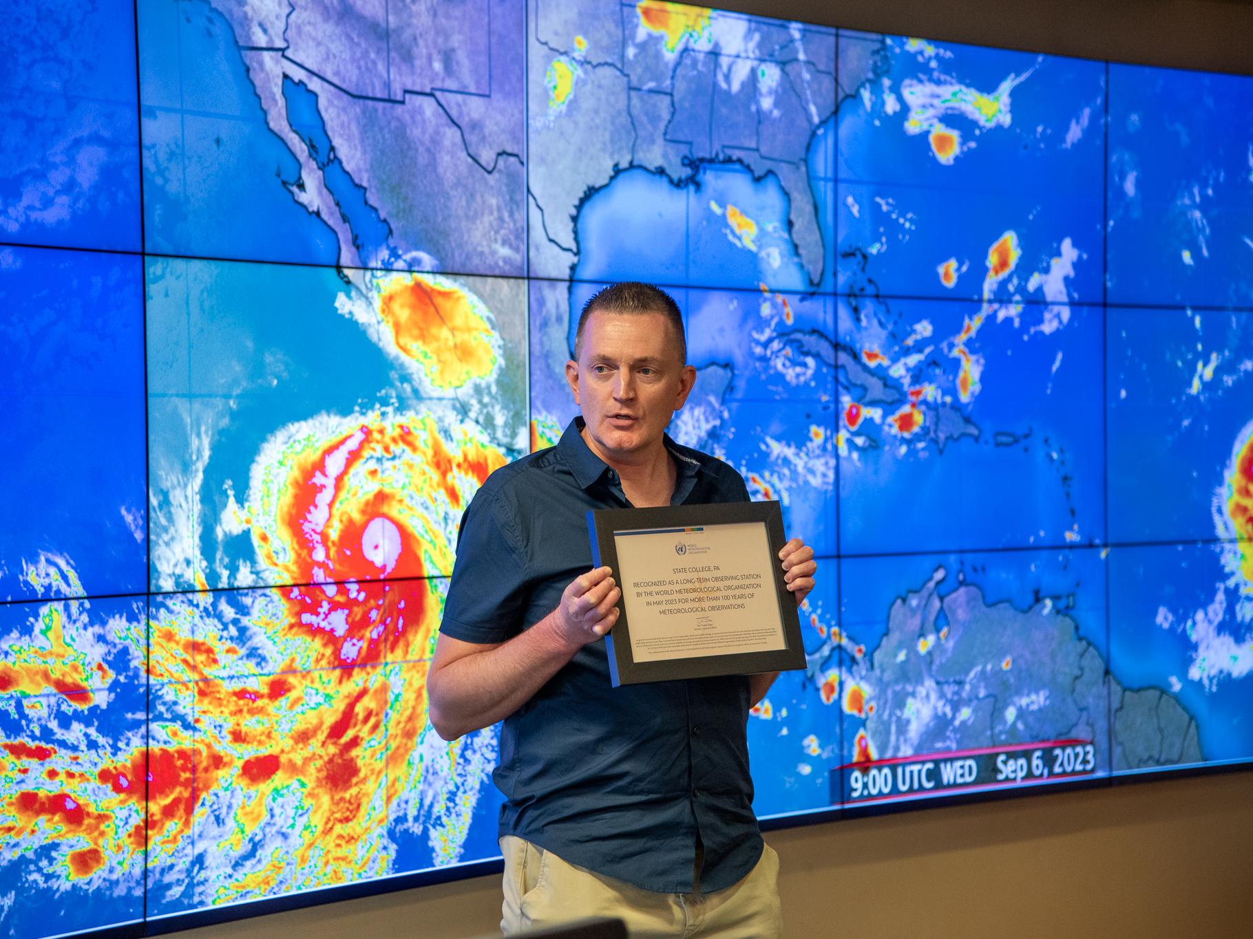 Chris Stachelski, of the National Weather Service, presents the award.