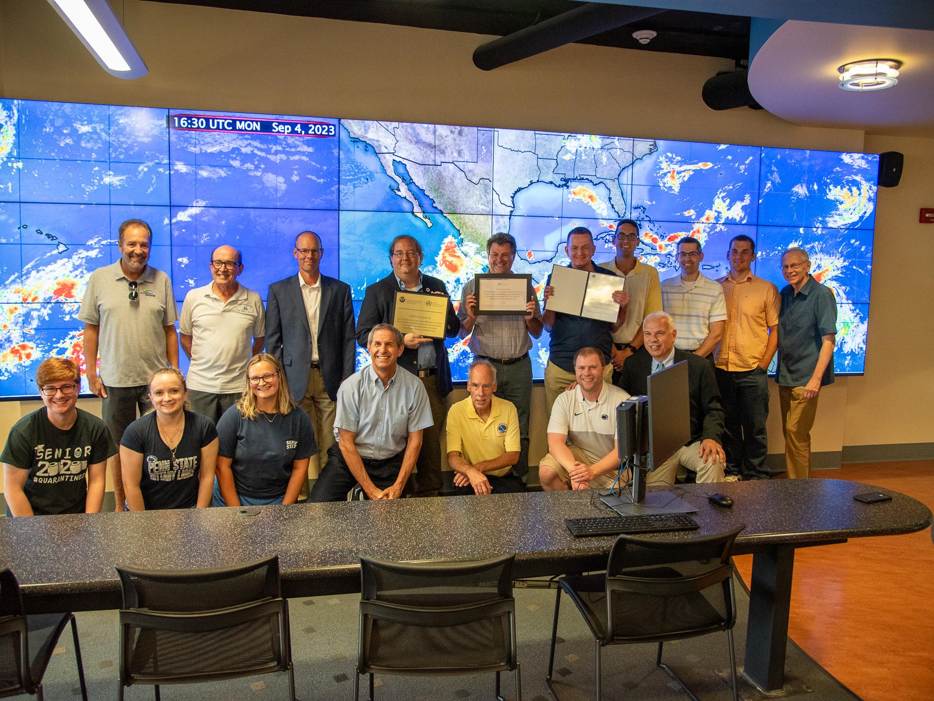 Weather experts display the World Meteorological Association award.