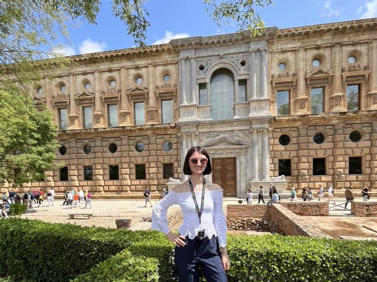 A person stands outside a building.