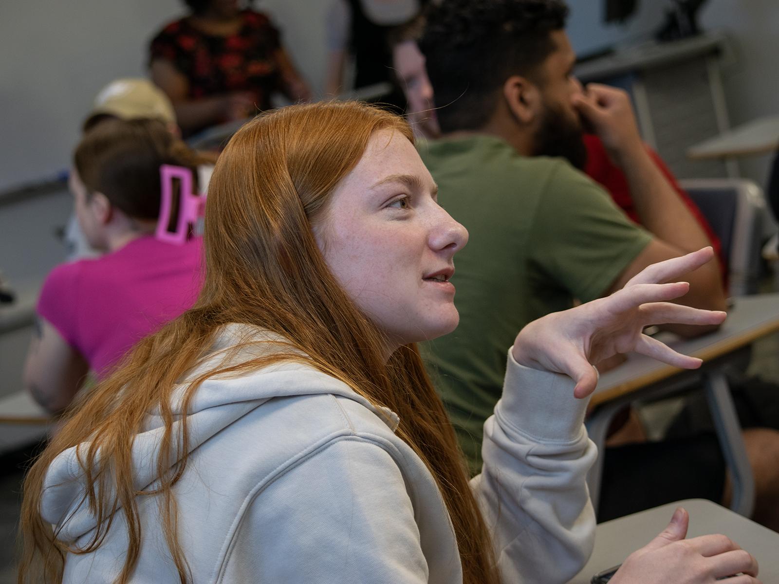 A student talks with a group about using virtual reality headsets
