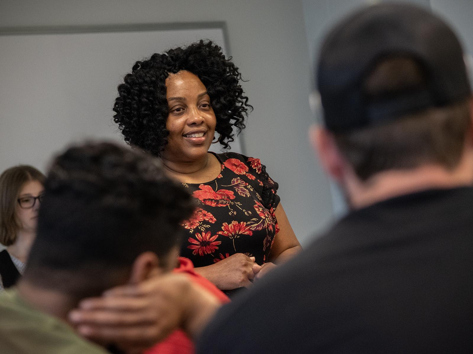 Shauntey James, assistant teaching professor of criminal justice at Penn State Harrisburg, talks with students in a classroom