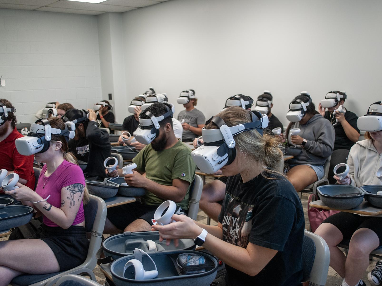 A classroom full of students wearing virtual reality headsets and holding the controllers