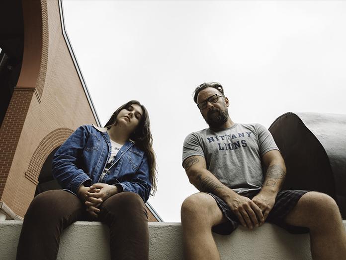young woman and man pose on Penn State campus