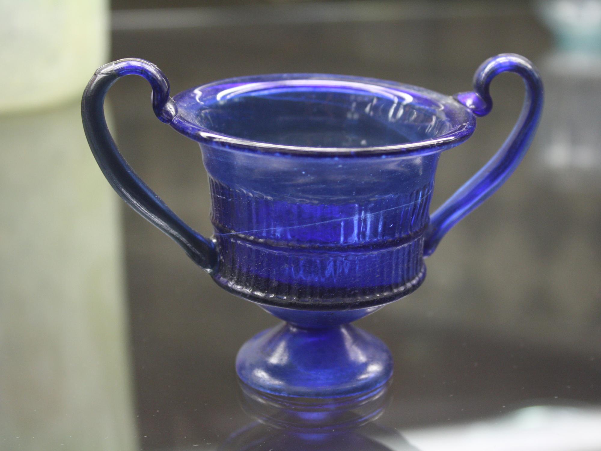 An ancient glass vase on a table