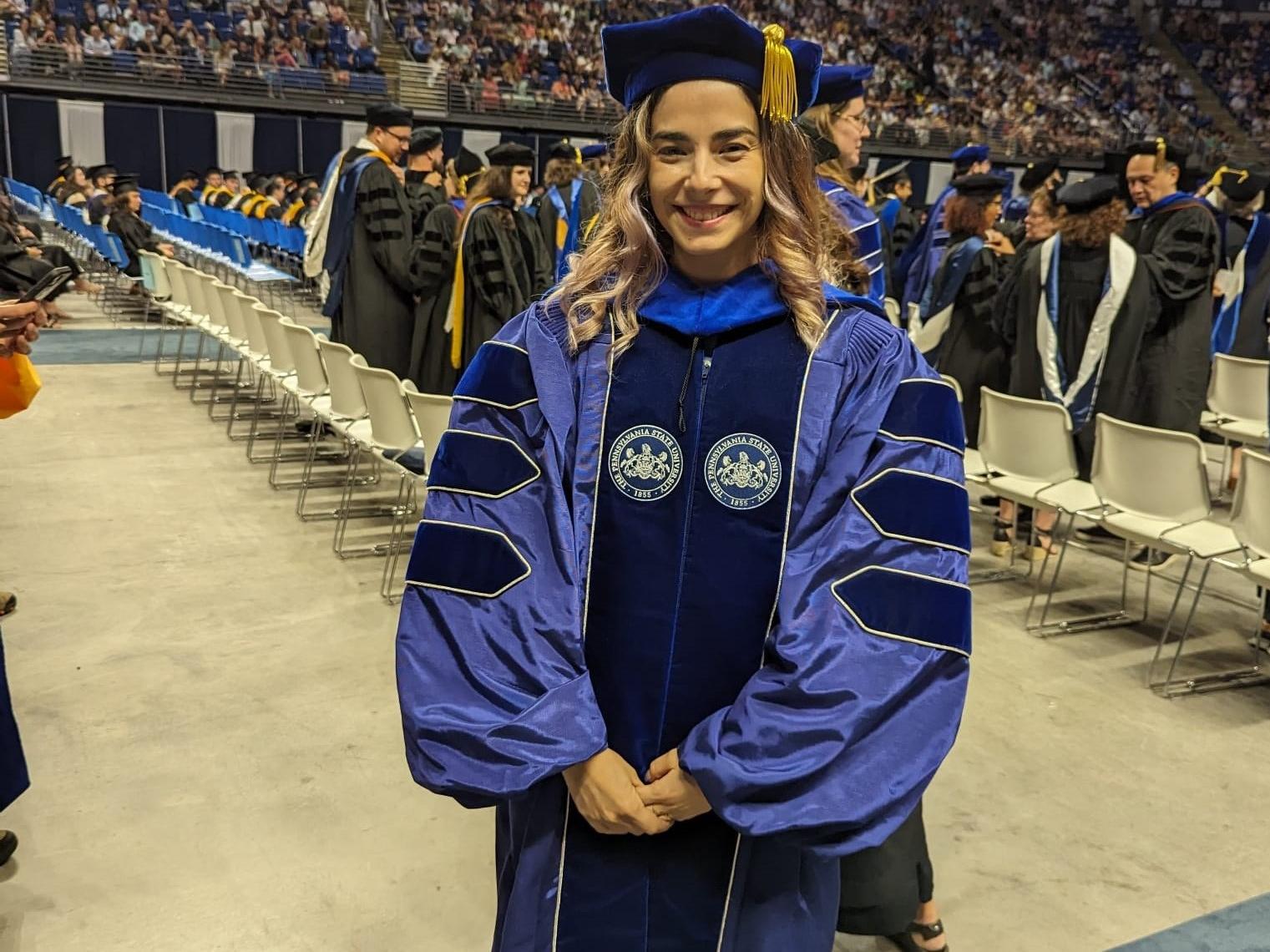 Headshot of Camila in graduation regalia