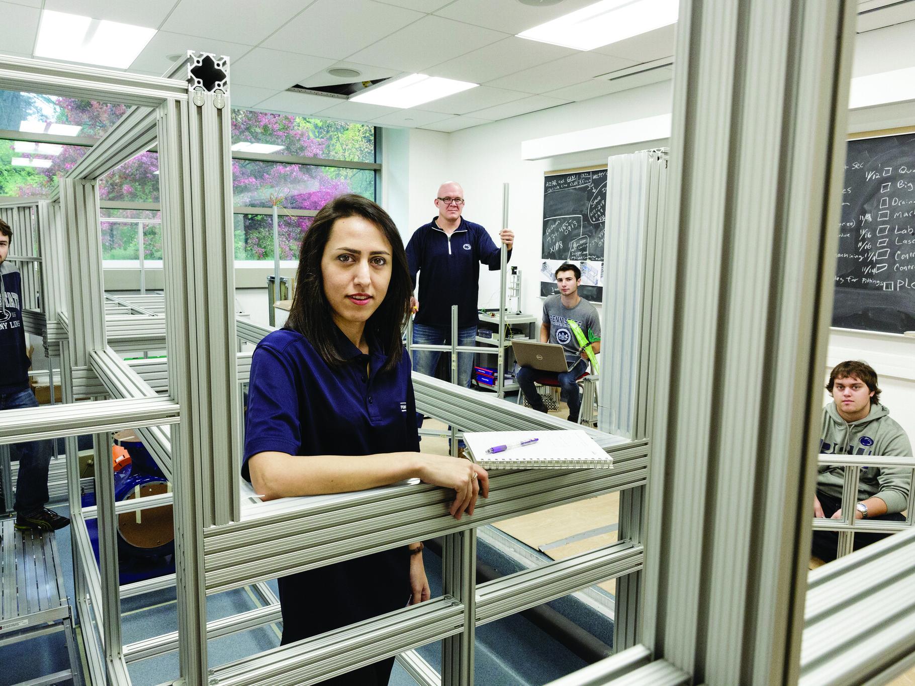 people in a room with metal framing