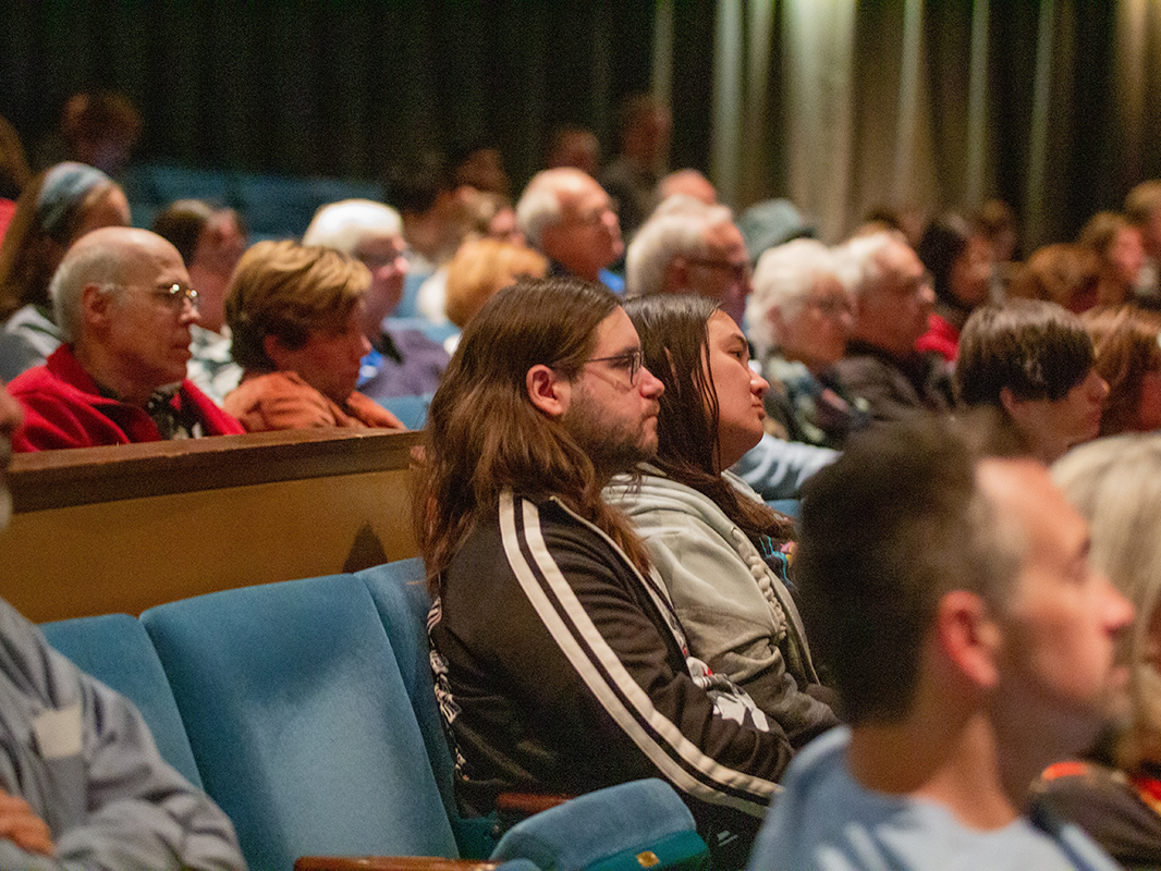Audience members listen to James Balog, Emmy Award-winning documentarian, explorer, environmentalist, and founder and president of the Earth Vision Institute, at the State Theatre on Oct. 26