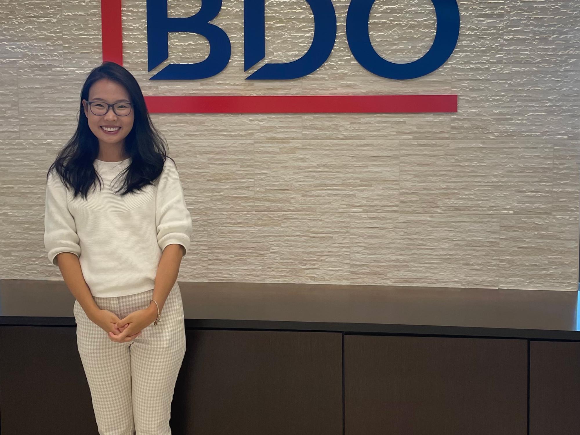 Bolortungalag Mijiddorj standing in front of a wall with the BDO logo