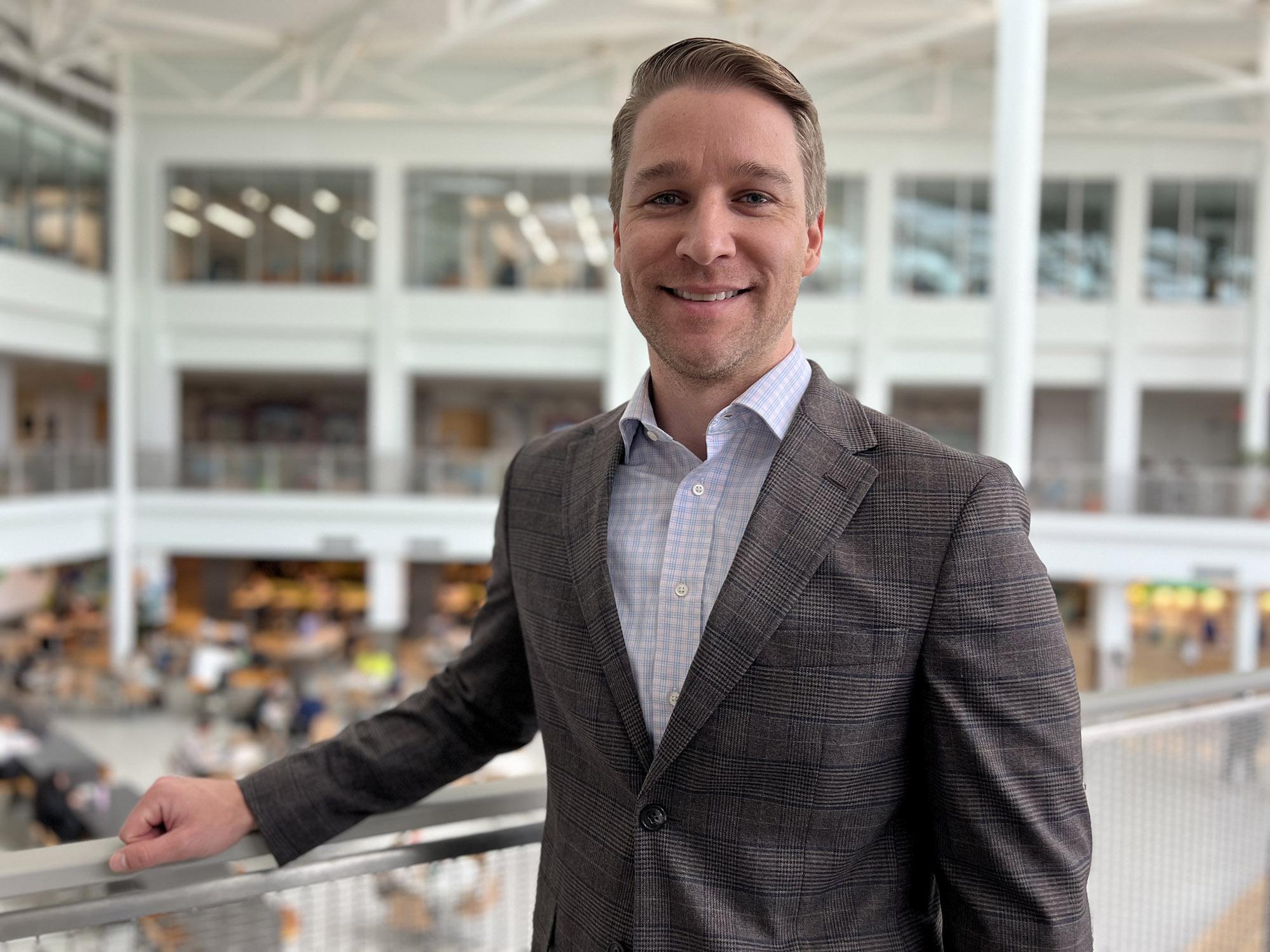 Dan Yesenosky stands with the HUB interior in the background