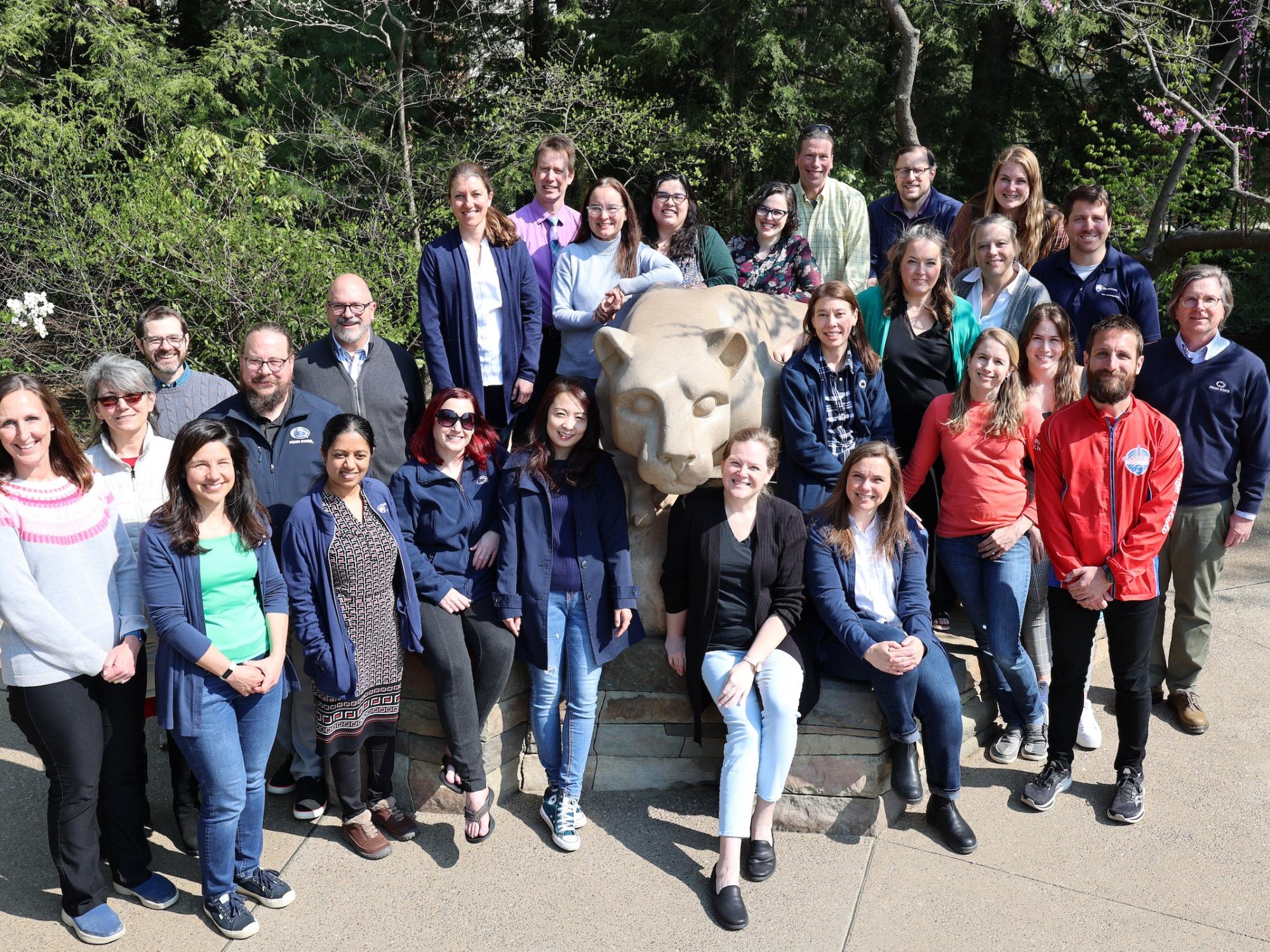DUS staff posing for photo at University Park lion shrine