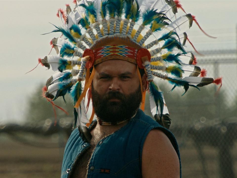 film still of man in native american headdress