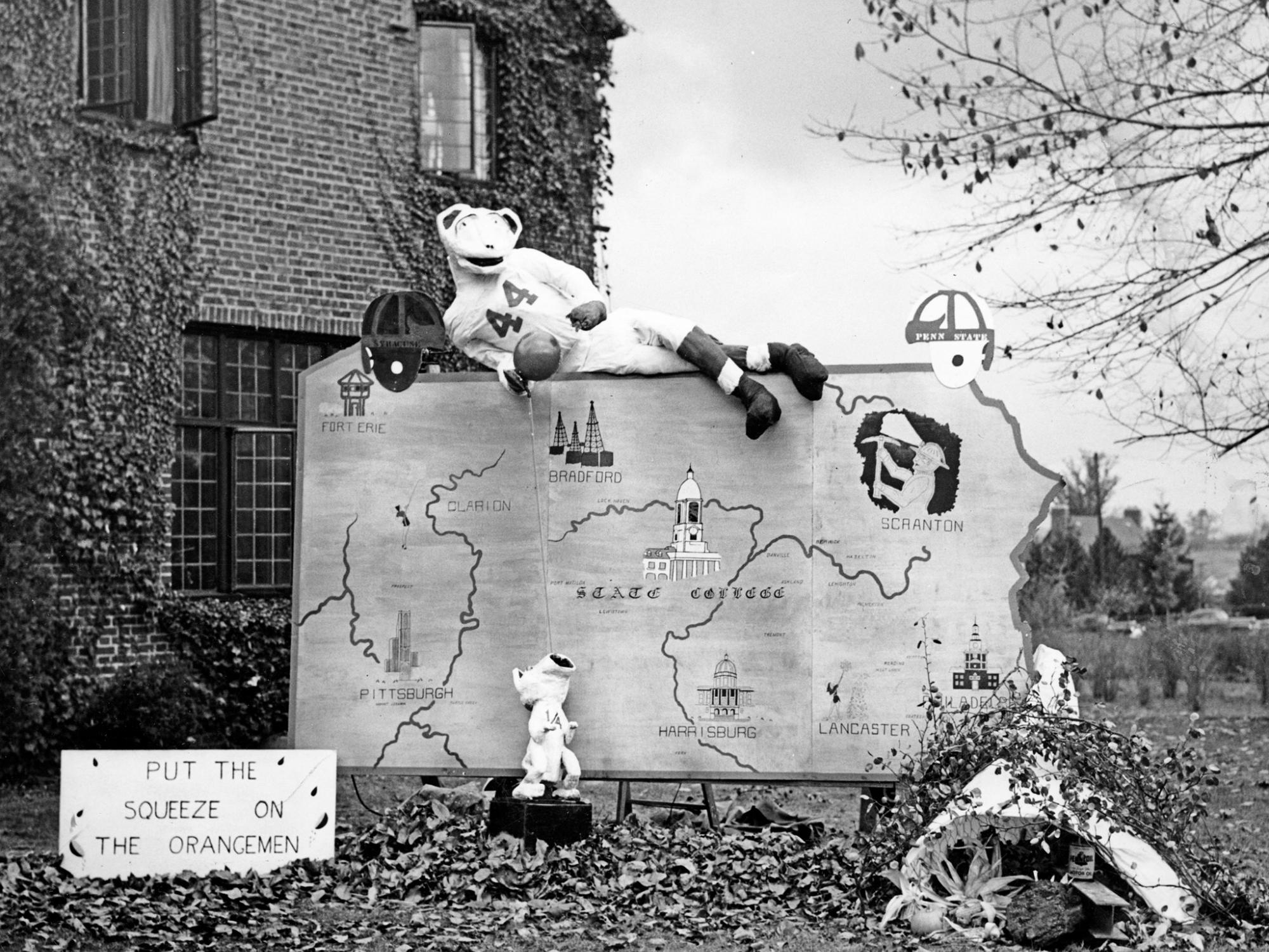 A Nittany Lion replica sits atop a cutout of the state of Pennsylvania