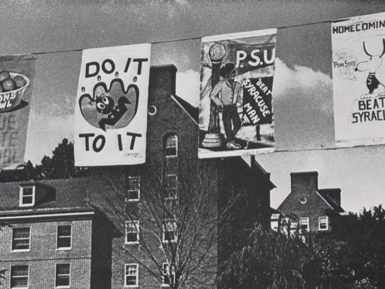 Four Homecoming banners hang above campus