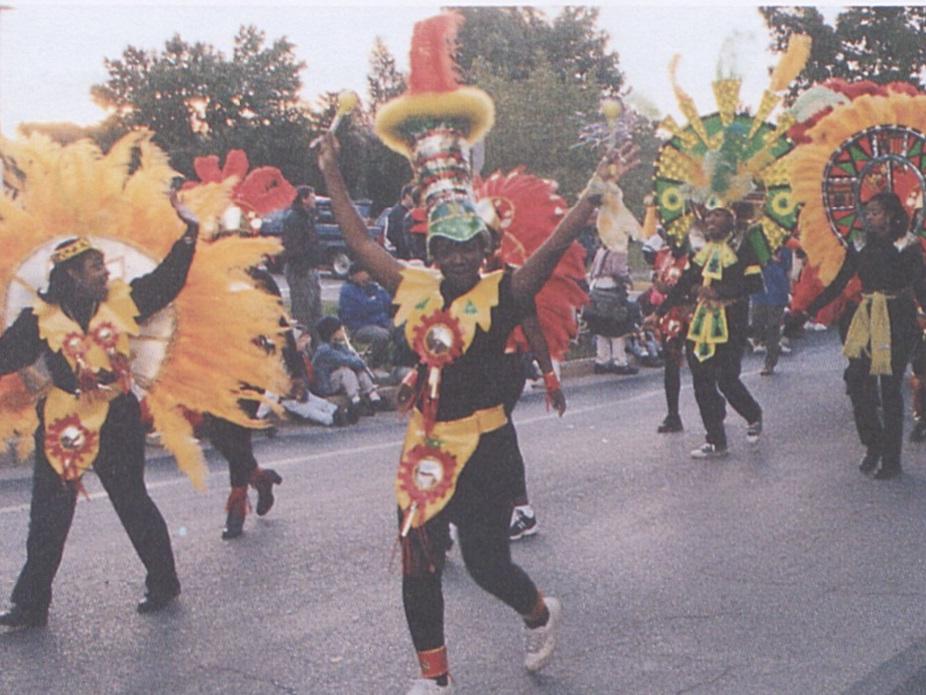 Students wearing colorful costumes march in the Homecoming parade in 1997.