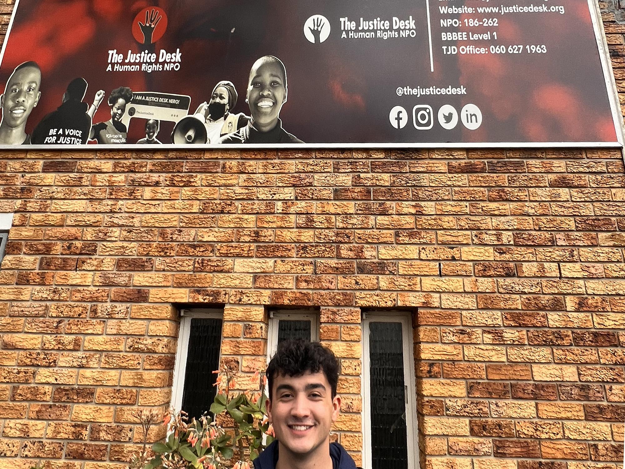 Ima Bazan, a fourth-year College of the Liberal Arts student, stands outside of Justice Desk Africa headquarters in Cape Town, South Africa. 