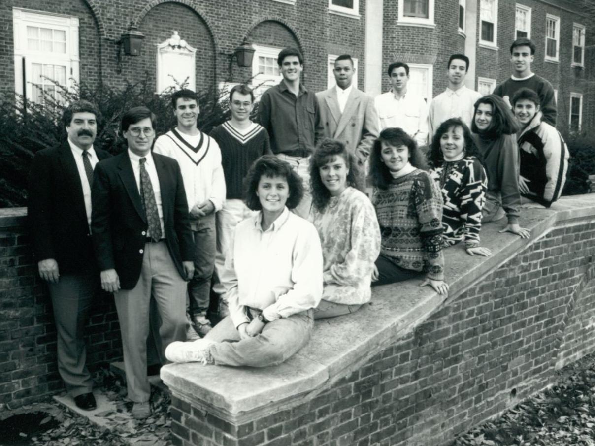 Students and two advisers posing for photo in front of Grange Building