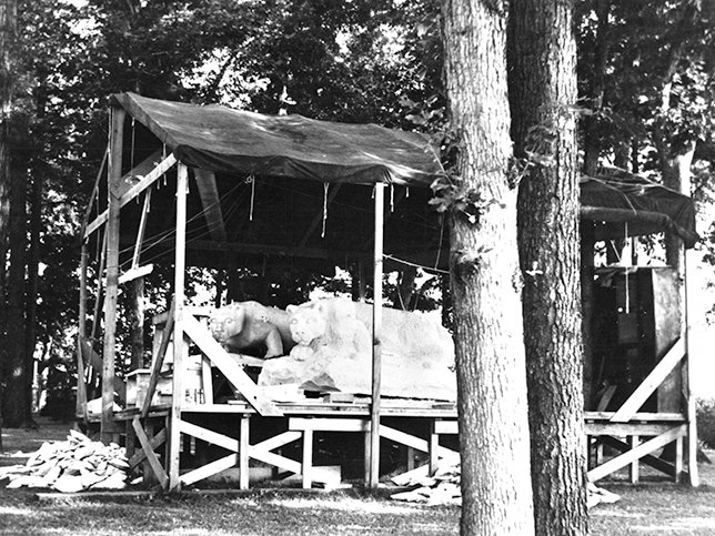 The carved Nittany Lion shrine sits next to a plaster model.