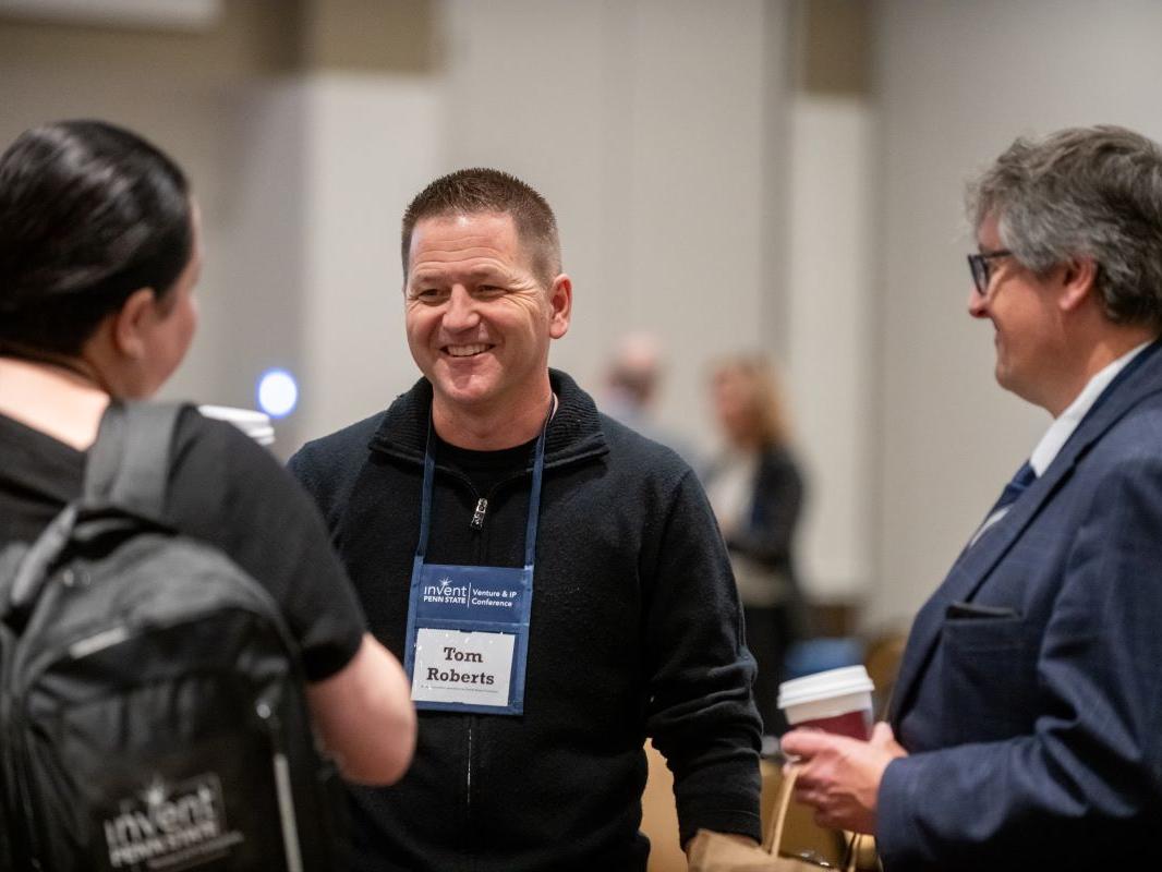 Three attendees network at the conference