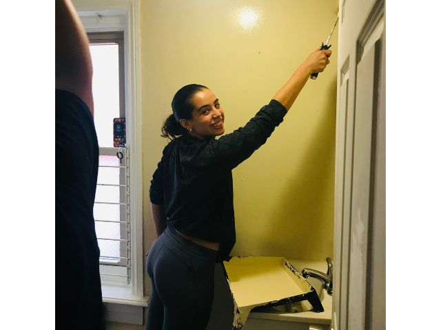 PSU-LV student paints a wall at Sixth Street Shelter, Allentown