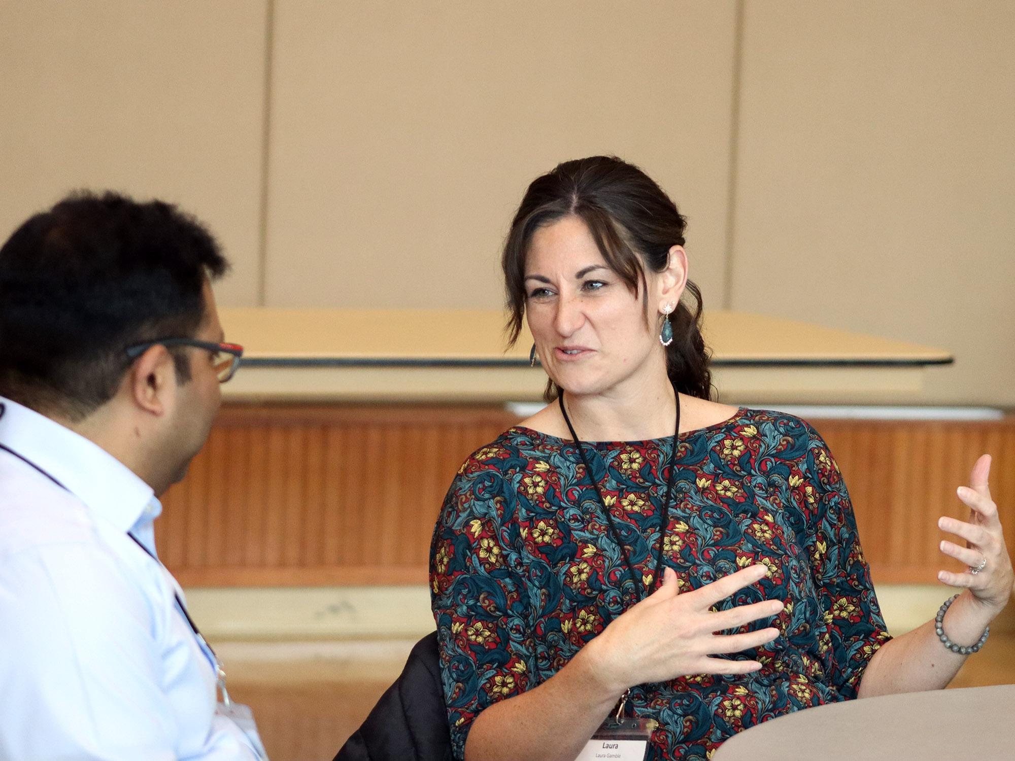 A student sitting talks to another one