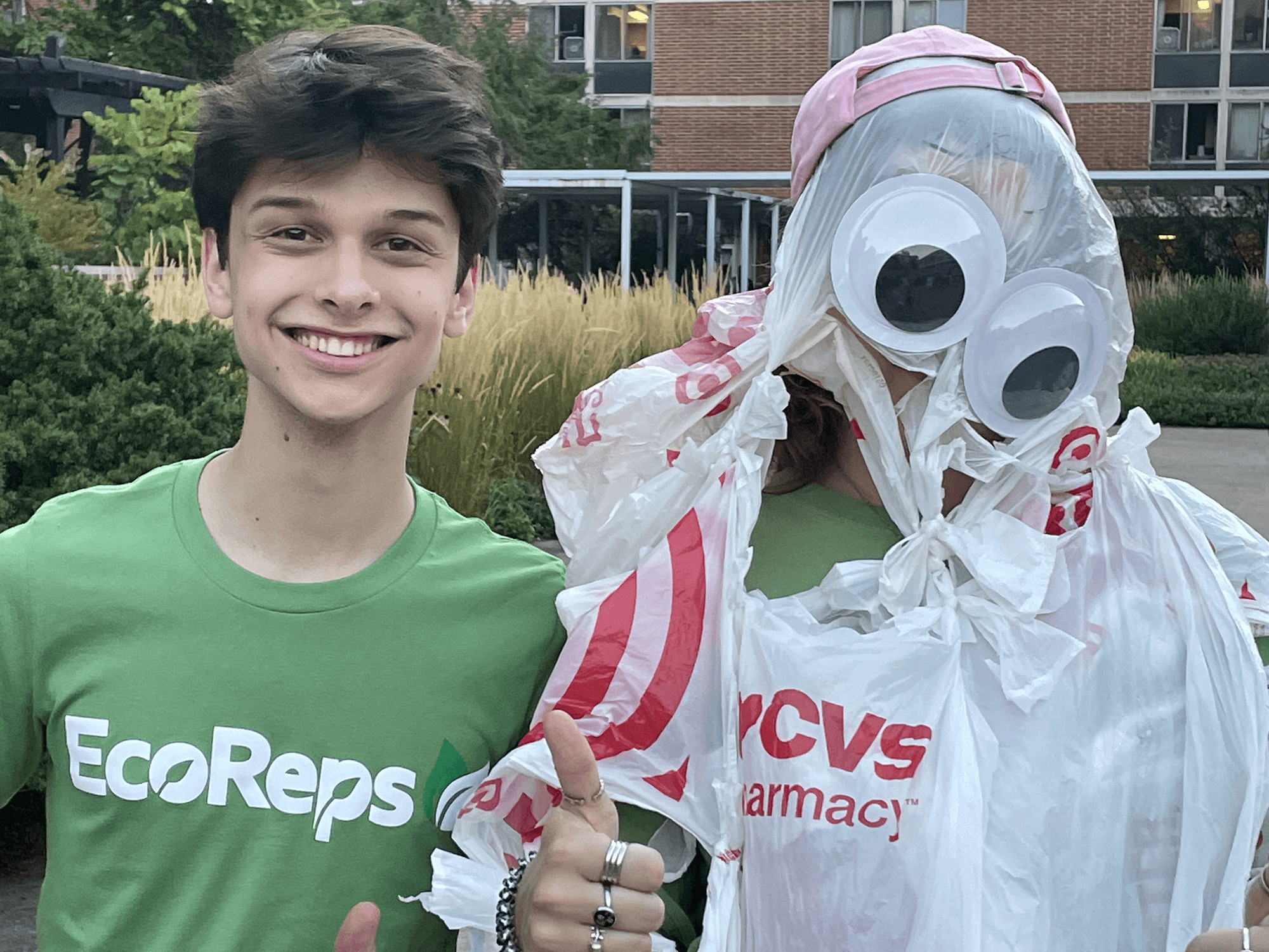 Ethan Sten stands to the left of a student dressed as Bagsquatch, the EcoReps mascot, for a photo during an ice cream social in East Halls at Penn State University Park. 